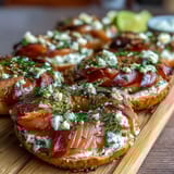 Vibrant Spring Brunch Smoked Salmon Bagel Board with Cream Cheese, fresh vegetables, and lemon wedges for a refreshing gathering centerpiece.