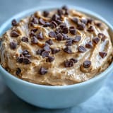 Creamy Fiber-Packed Chickpea Cookie Dough Dip with chocolate chips for dipping.
