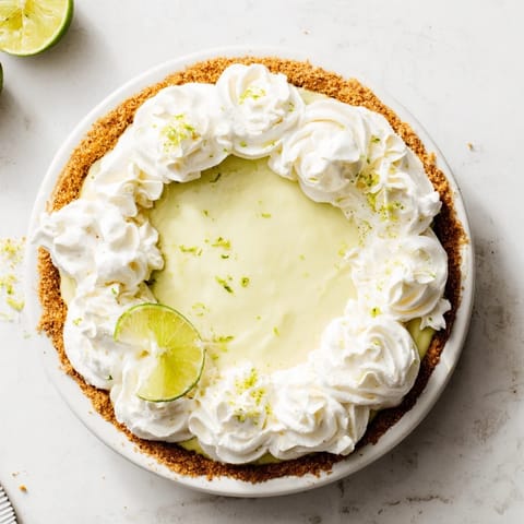 Bright slice of key lime pie, showcasing creamy filling and graham cracker crust.