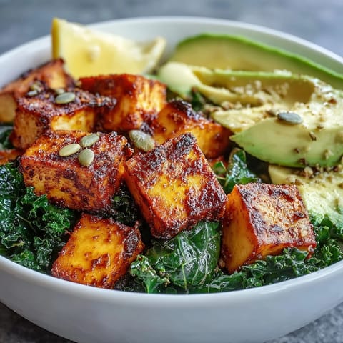 Freshly prepared Tofu Breakfast Bowl with Avocado and Kale showcases fluffy turmeric tofu, bright green kale, and pumpkin seeds for a nourishing vegan breakfast.