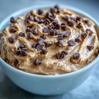 Creamy Fiber-Packed Chickpea Cookie Dough Dip with chocolate chips for dipping.